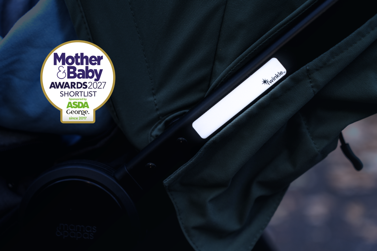 Close up of reflective stickers on pram in low light, with Mother & Baby Awards 2027 Shortlist bage in top left corner of image